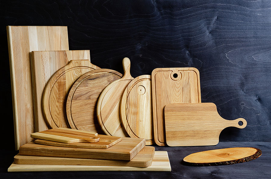 many hand-made wooden cutting boards