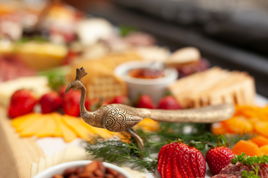 close up picture of a brass handle on a charcuterie board