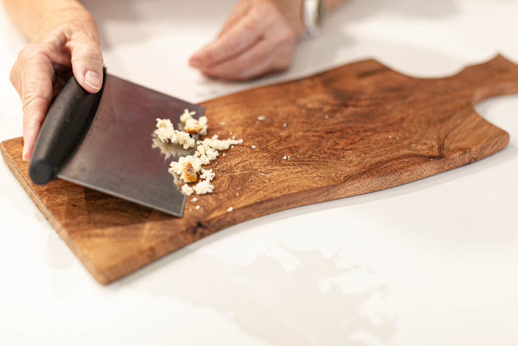 picture of a bench scraper and food particles on a cutting board