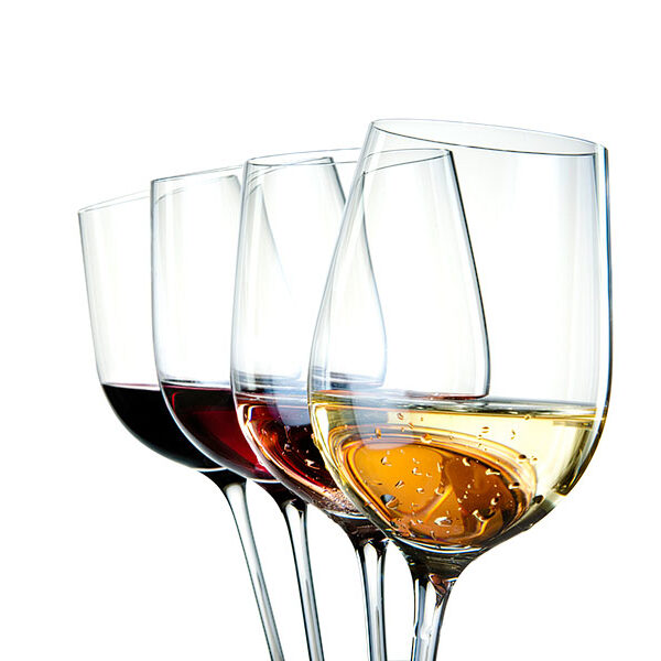 Four wine glasses with different colors of wine